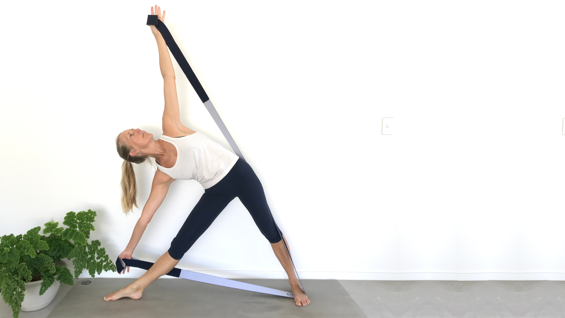 How to practice Yoga's Triangle Pose with resistance bands. How to practice Yoga's Triangle Pose with resistance bands.