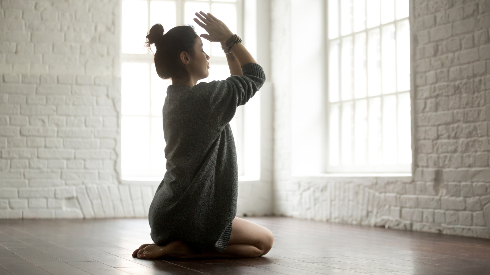 How to practice yoga for the purpose of self inquiry and self healing. Young attractive yogi woman practicing yoga, sitting in Vajrasana Pose.