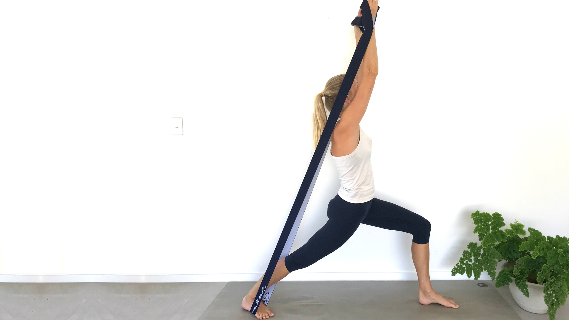 How to practice Yoga's Warrior l Pose with arms raised high using resistance bands to build strength. How to use Resistance Bands in yoga's Warrior l Pose with arms raised high