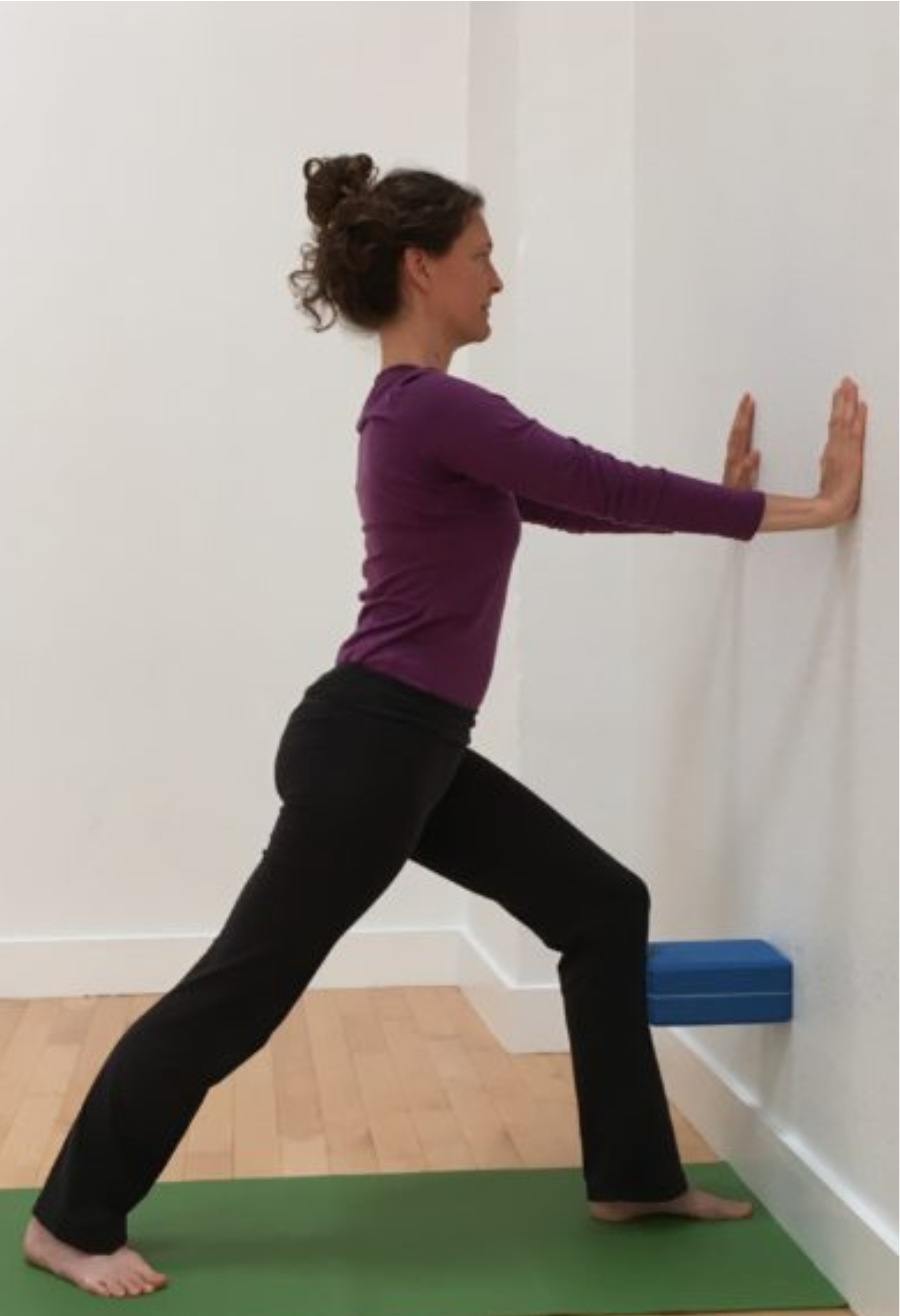 Warrior 1 or Virabhadrasana 1 with backbend at the wall. 